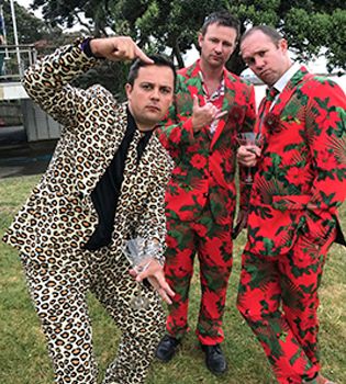 Three men in whacky suits posing