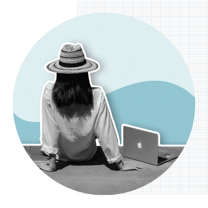 Women sitting on beach with laptop