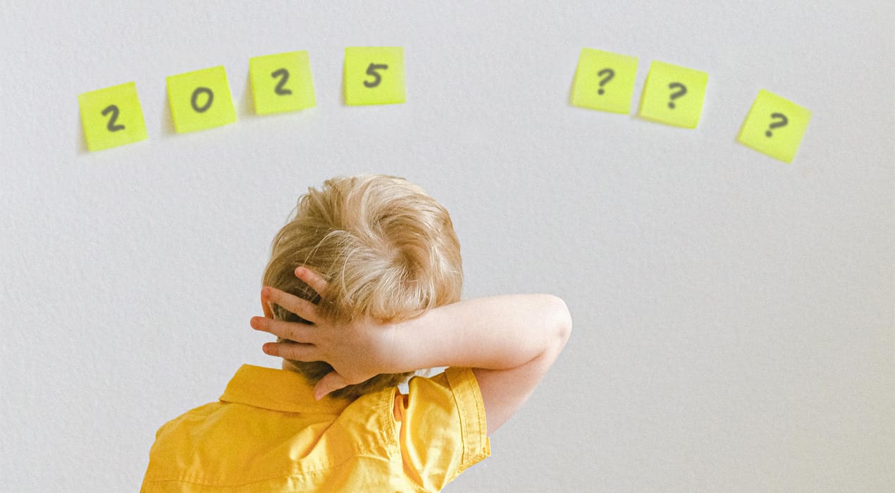 Child looking at Post-it notes on a wall which read "2025 ???"